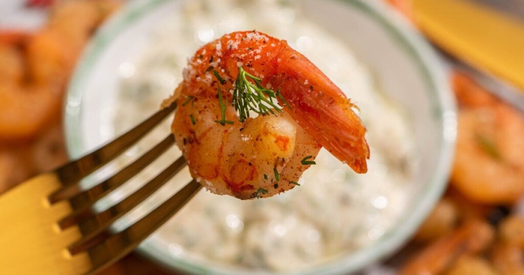 cooked shrimp on fork curled