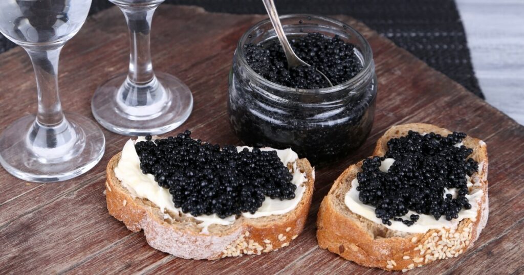 black caviar served with spoon on bread